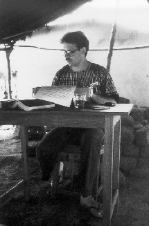Philip Graham clomping away at a typewriter in the village of Asagbé, 1985.